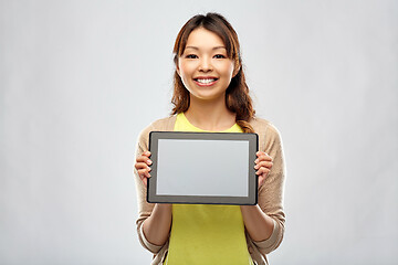 Image showing happy asian woman showing tablet computer