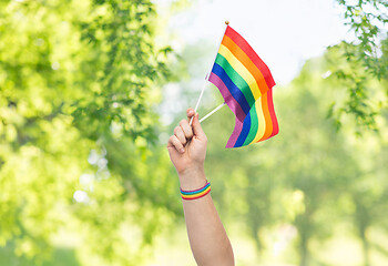 Image showing hand with gay pride rainbow flags and wristband