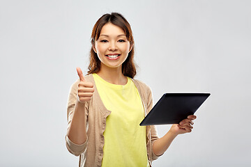 Image showing happy asian woman using tablet computer