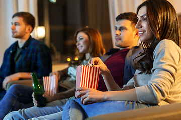 Image showing friends with beer and popcorn watching tv at home