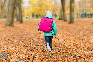 Image showing little girl with school bag at autumn park