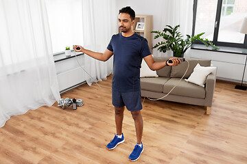 Image showing indian man exercising with jump rope at home