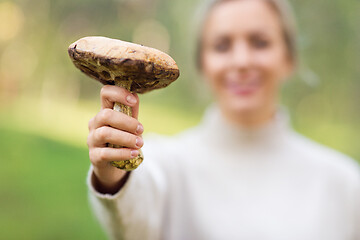 Image showing close up of woman with mushroom in forest