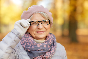 Image showing portrait of happy senior woman at autumn park