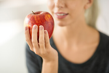 Image showing close up of woman holding ripe red apple