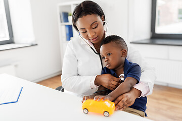 Image showing doctor with stethoscope and baby patient at clinic