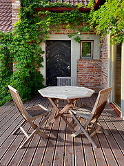 Image showing terrace with wooden table and chairs