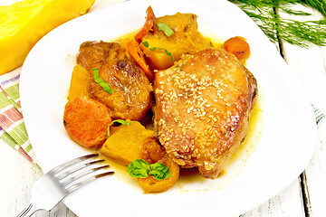 Image showing Chicken roast with pumpkin and dried apricots on white board