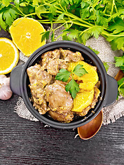 Image showing Liver with oranges in pan on dark board top