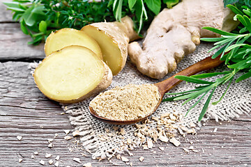 Image showing Ginger ground in spoon with root on old board