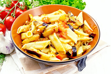 Image showing Pasta penne with eggplant and tomatoes on board