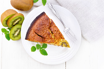 Image showing Pie with kiwi in plate on board top