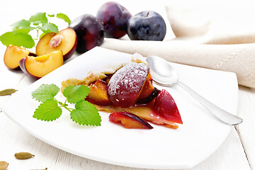 Image showing Galeta with plums in plate on white board