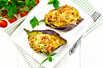 Image showing Eggplant stuffed smoked brisket in plate on wooden board top