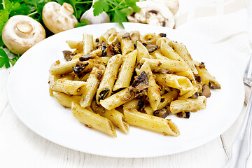 Image showing Pasta with mushrooms in white plate on board