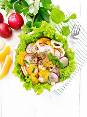 Image showing Salad of radish and orange with mint on white board top