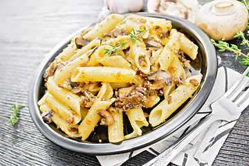 Image showing Pasta with mushrooms in plate on dark board