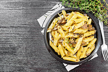 Image showing Pasta with mushrooms in plate on black board top