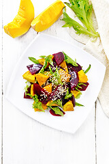 Image showing Salad of pumpkin and beetroot in plate on light board top