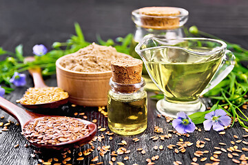 Image showing Oil flaxseed with flour and seeds on board