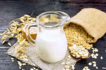 Image showing Milk oatmeal in jug on burlap