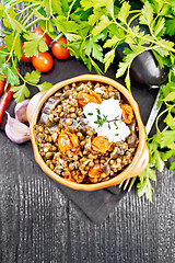 Image showing Lentils with eggplant and tomatoes in bowl on board top