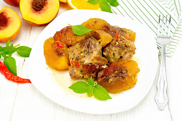Image showing Turkey with peaches in plate on wooden board