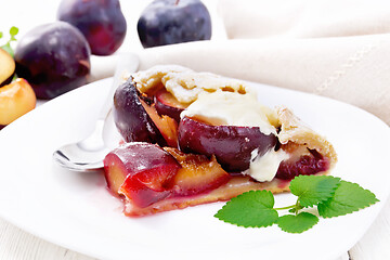 Image showing Galeta with plums in plate on light table