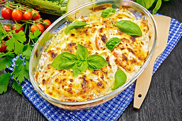 Image showing Zucchini baked with tomatoes in pan on towel