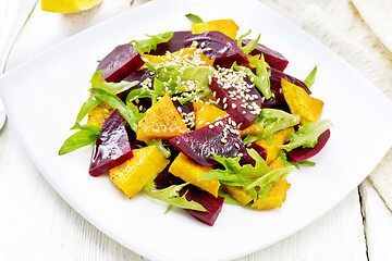 Image showing Salad of pumpkin and beetroot in plate on board