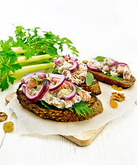 Image showing Bruschetta with fish and curd on light board