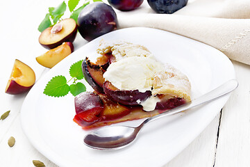 Image showing Galeta with plums in plate on white table