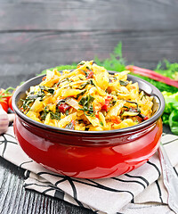 Image showing Cabbage stew with chard in bowl on wooden board