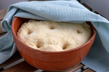 Image showing leavened dough in a clay bowl