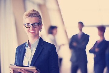 Image showing business woman  at office with tablet  in front  as team leader