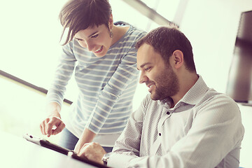 Image showing Two Business People Working With Tablet in startup office