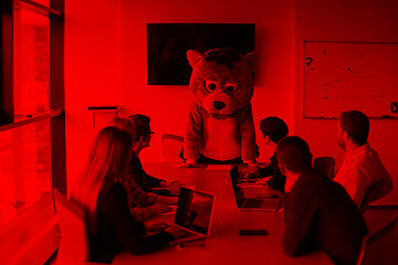 Image showing boss dresed as bear having fun with business people in trendy of