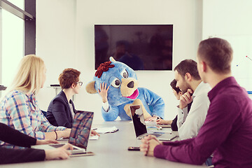 Image showing boss dresed as bear having fun with business people in trendy of