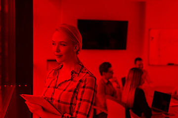 Image showing Pretty Businesswoman Using Tablet In Office Building by window