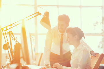 Image showing business couple working together on project, sunrise in backgrou