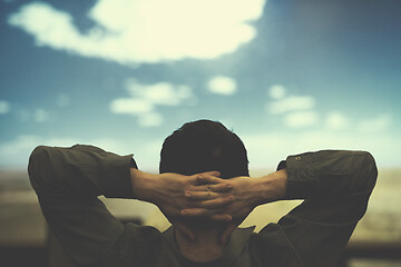 Image showing young man dreaming clouds on presentation