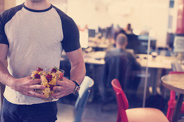 Image showing software developer eating a fruit salad