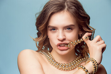 Image showing Beautiful young girl in studio with pearl jewelry - earrings, bracelet, necklace.