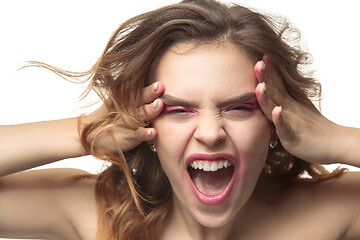 Image showing The young emotional angry woman screaming on white studio background