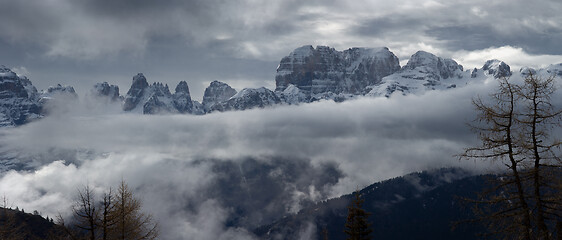 Image showing Snow-capped alps mountains in clouds