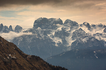 Image showing Snow-capped alps mountains in clouds