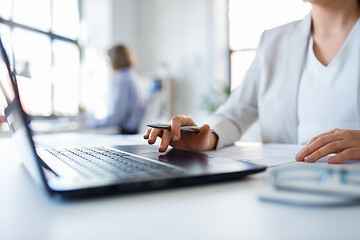 Image showing businesswoman with laptop working at office