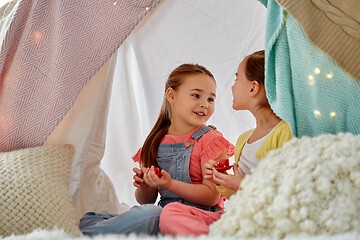 Image showing little girl playing tea party in kids tent at home