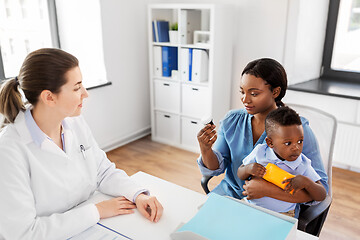 Image showing doctor and woman with baby and medicine at clinic