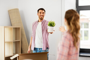 Image showing happy couple with stuff moving to new home